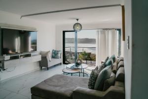 a living room with a couch and a table at Gonubie Beachside Delight in East London