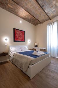 a bedroom with a large bed with a wooden ceiling at The Heartbeat of Bohemian Rome in Rome