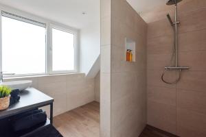 a bathroom with a shower and a sink at Short Stay Zandvoort at 68 in Zandvoort +37 photos