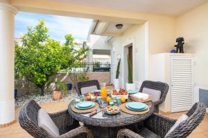 a table with chairs and food on a patio at Beautiful townhouse in downtown Ferragudo in Ferragudo