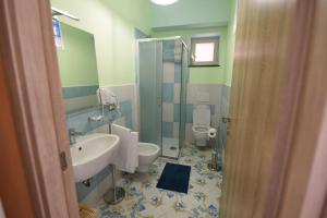 a bathroom with a sink and a toilet at La Casa Dei Desideri in Agerola