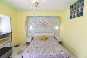 a bedroom with a bed and a chandelier at La Casa Dei Desideri in Agerola +18 photos