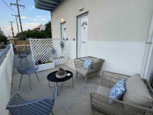 a patio with chairs and a table on a balcony at Divine Studios Elafonisos A2 in Elafonisos