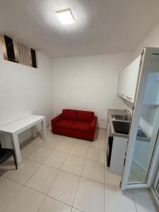 a kitchen with a red couch in a room at Dimora Doria in Bari