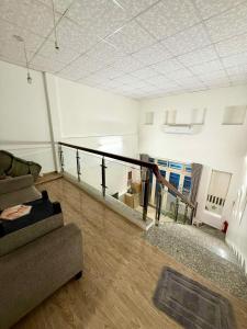 a living room with a couch and a staircase at 2 floors -2 sleeps - full furniture in Da Nang