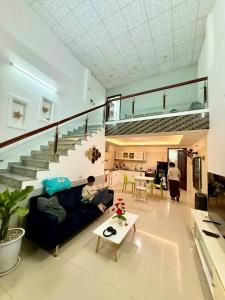a man sitting on a couch in a living room at 2 floors -2 sleeps - full furniture in Da Nang