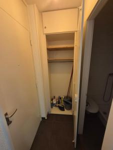 a small bathroom with a closet with a toilet at Studio proche gare et Lausanne in Renens