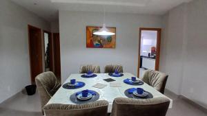 a dining room with a table with blue dishes on it at Cozy Apartment in Domingos Martins