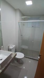 a bathroom with a shower and a toilet and a sink at Cozy Apartment in Domingos Martins