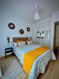 a bedroom with a large bed with a yellow blanket at Roma Bella in El Burgo de Osma +24 photos
