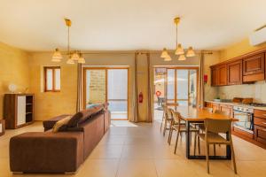 a living room with a couch and a table at Nadurija Holiday Home in Nadur