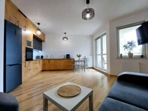a living room with a couch and a table at Apartament Kolejowa 16 in Olsztynek