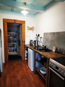 a kitchen with a counter and a stove top oven at Ubytovanie Domček Paradajz in Banská Štiavnica