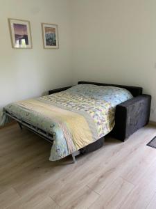 a bed in a bedroom with a bed frame at Charming studio between lakes and mountains in La Biolle
