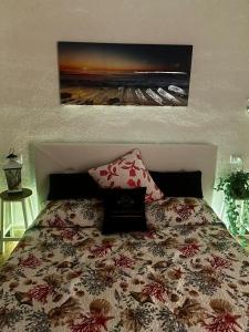 a bedroom with a bed with a floral bedspread at Your Exclusive Apartment near Santa Teresa Gallura in Porto Pozzo