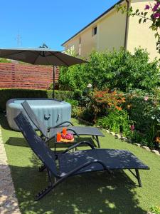a picnic table and an umbrella next to a tub at Jacuzzi House Kaštela - Parking - Playground in Kaštela +25 photos