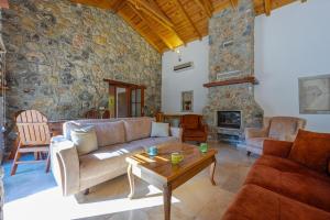 a living room with a couch and a table at Villa Candy Stone, Private Pool Villa for 8 People in Fethiye