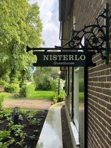 a sign on the side of a building at Nisterlo Guesthouse in Nistelrode