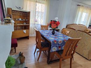 ein Esstisch mit einer Vase mit Blumen darauf in der Unterkunft Taku Villa Wonderful view of Lake Ohrid in Udënisht + 23 Fotos