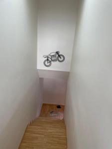a small staircase with a bike on the ceiling at Moto Albergue Farango FOR MOTORBIKERS ONLY - SOLO PARA MOTEROS in Benabarre