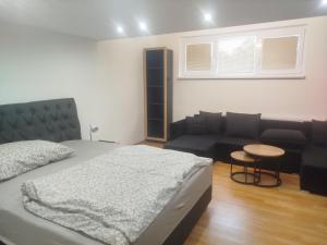 a bedroom with a bed and a couch at 3 Room apartment,parking in Železničná Stanica Petržalka +5 photos