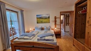 a bedroom with a large bed with blue pillows at Ferienwohnung Springl in Schönau am Königssee