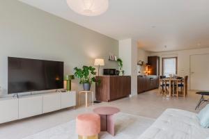 a living room with a large flat screen tv at Appartement familial 5 min Disney 30 min Paris in Montévrain