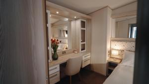 a bedroom with a desk and a bed and a mirror at New Forest Retreat on a Holiday Park in New Milton