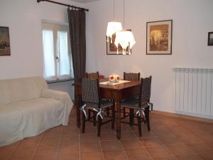 a living room with a table and chairs and a couch at Agriturismo Tenuta Buon Respiro in Orvieto
