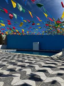 a blue wall with colorful kites flying in the sky at Espaço Vó Margarida in Caruaru