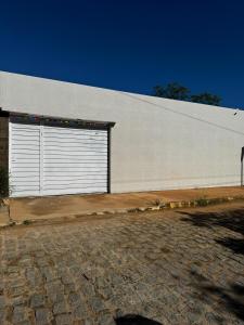 a large white building with a large garage door at Espaço Vó Margarida in Caruaru