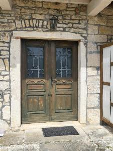 an old wooden door on a stone building at Klunj home in Buje