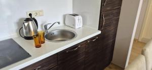 a kitchen with a sink and a toaster on a counter at Patrick's apartments - Harmony Palace in Sunny Beach +8 photos