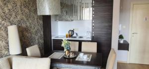 a kitchen with a table with chairs and a sink at Patrick's apartments - Harmony Palace in Sunny Beach