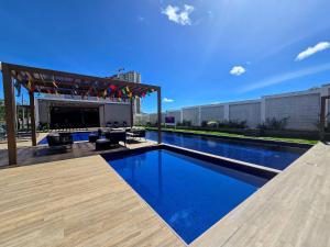 a swimming pool with a pergola on a building at Apê La Belle de Jour no residencial Ipojuca II in Caruaru +19 photos