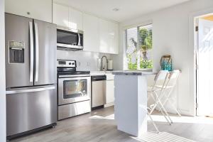 a kitchen with white cabinets and stainless steel appliances at Waterfront Cabana 3 Key Largo in Key Largo