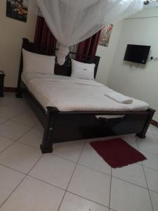 Postel nebo postele na pokoji v ubytování Harambee paradise hotel