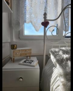 a bedroom with a bed with a lamp and a window at Happy Place in Niš +20 photos