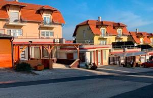 a row of houses with orange roofs on a street at Krisztina apartman in Zalakaros