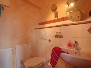 a bathroom with a sink and a toilet and a mirror at Ferienwohnung Kogge im Zentrum von Röbel in Röbel +31 photos