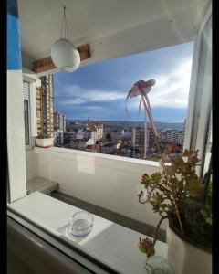 a window with a view of a city at Happy Place in Niš