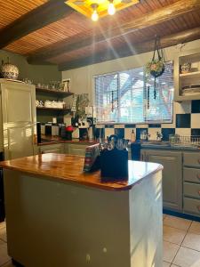 a kitchen with a wooden counter top in a kitchen at Tranquil Bush Cottage at Kruger in Marloth Park +31 photos