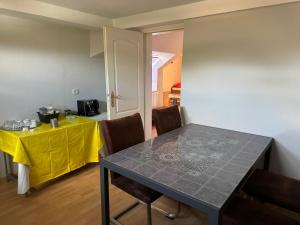 a dining room with a table and a yellow table cloth at Gasthaus Wicky in Hemdingen