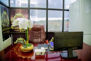 a computer monitor sitting on a desk in an office at Blaize Affaire apartments in Kampala