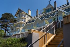 a large house with stairs in front of it at Tors Park in Lynmouth