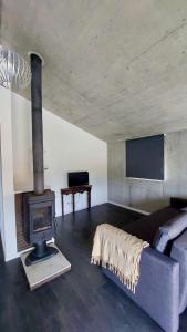a living room with a fireplace and a couch at Quinta da Cortelhinha Turismo Rural in Oliveira do Hospital