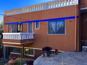 a large brick building with a balcony on it at Caramel Cloud in Mytilene
