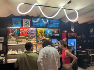 a group of people standing at a counter in a store at Andaman Genetics 420 Rooms in Ao Nang 