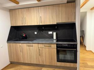 a kitchen with black counter tops and wooden cabinets at Gemütliche Wohnung in Gaggenau-Ottenau in Gaggenau