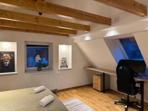 a bedroom with a desk and a computer in it at Gemütliche Wohnung in Gaggenau-Ottenau in Gaggenau